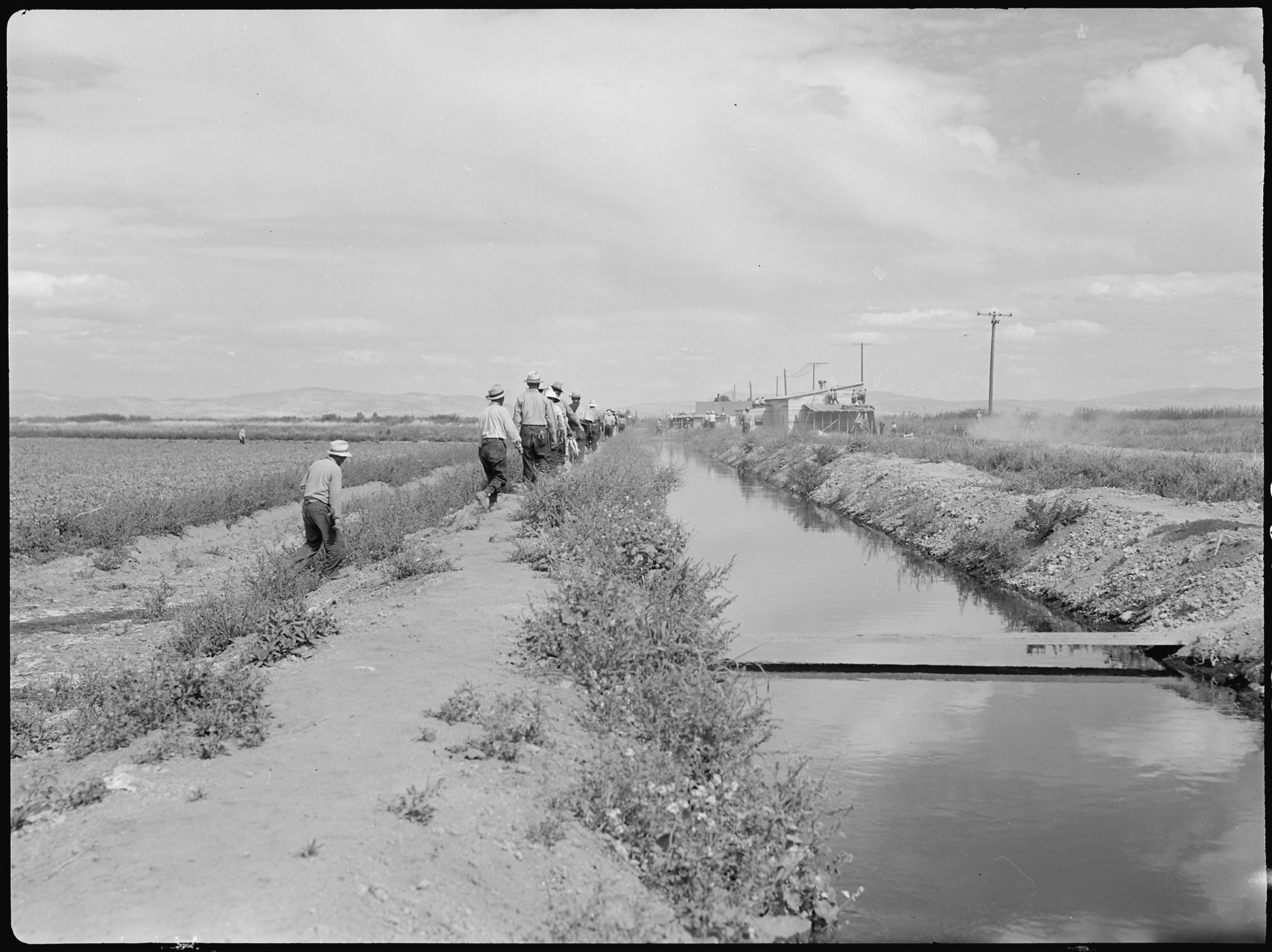 This view shows an irrigation ditch which supplies the water for the farm run by evacuee workers at this relocation center