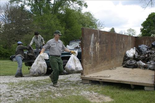 RiverDay trash clean up staff and volunteers at dumpster