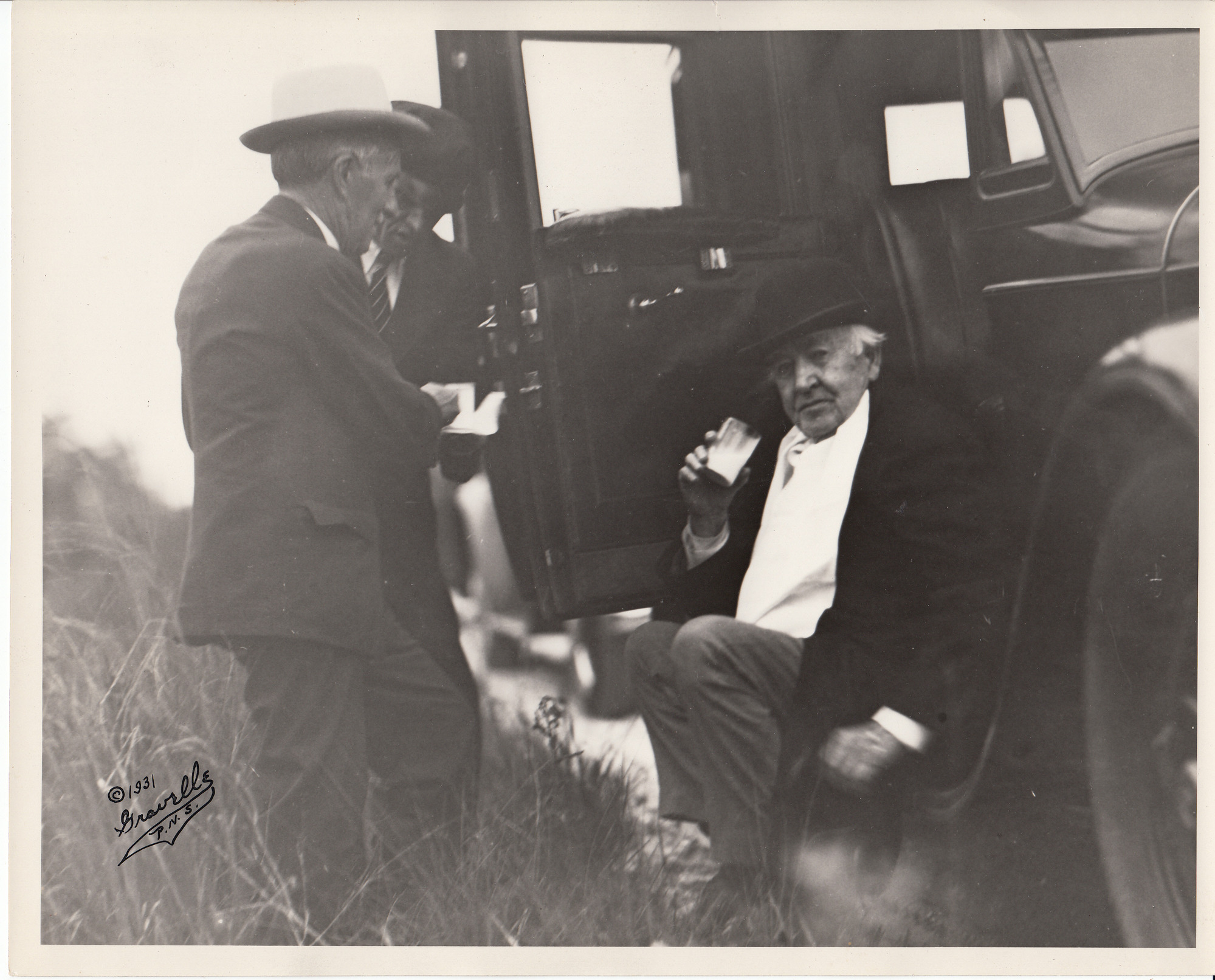 Thomas Edison, Harvey Firestone, and unidentified man stopping for a drink along the Tamiami Trail.