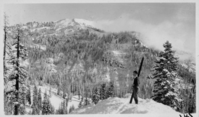 Holmes and Skis by Black Butte. Arthur G. Holmes Collection Album 5: Holmes and other man at Black Butte beside road with Lassen Peak in background, and skiing in woods