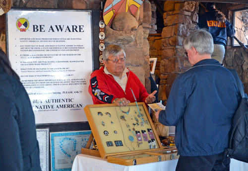 Tony Eriacho, Zuni carver and jeweler is discussing authentic American Indian crafts with park visitor. 