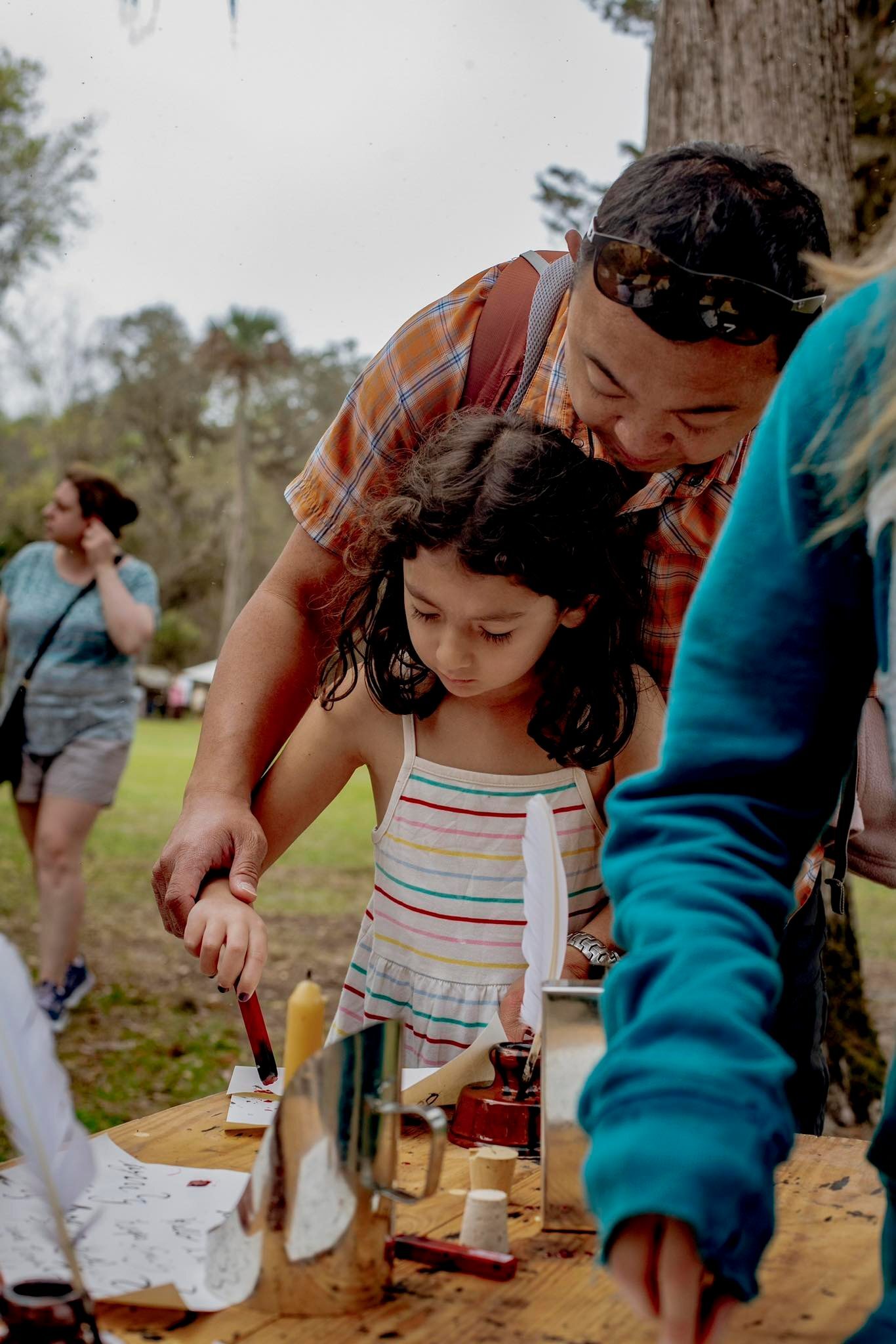 child and adult with sealing wax