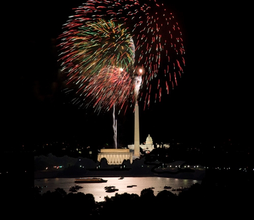 Shots of fireworks going off above the National Mall.