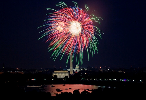 Shots of fireworks going off above the National Mall.
