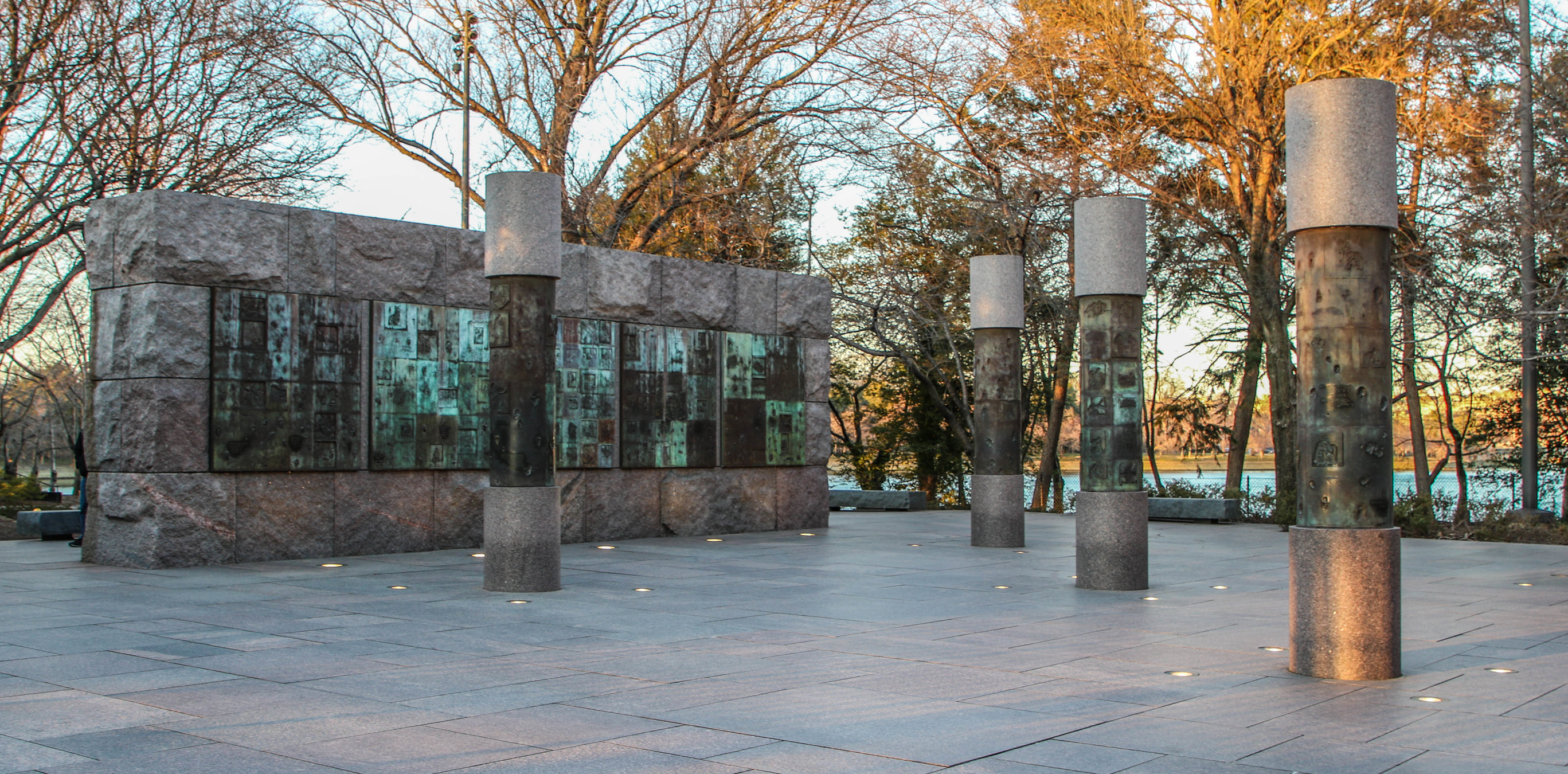 Stone wall and columns with engraved metal panels
