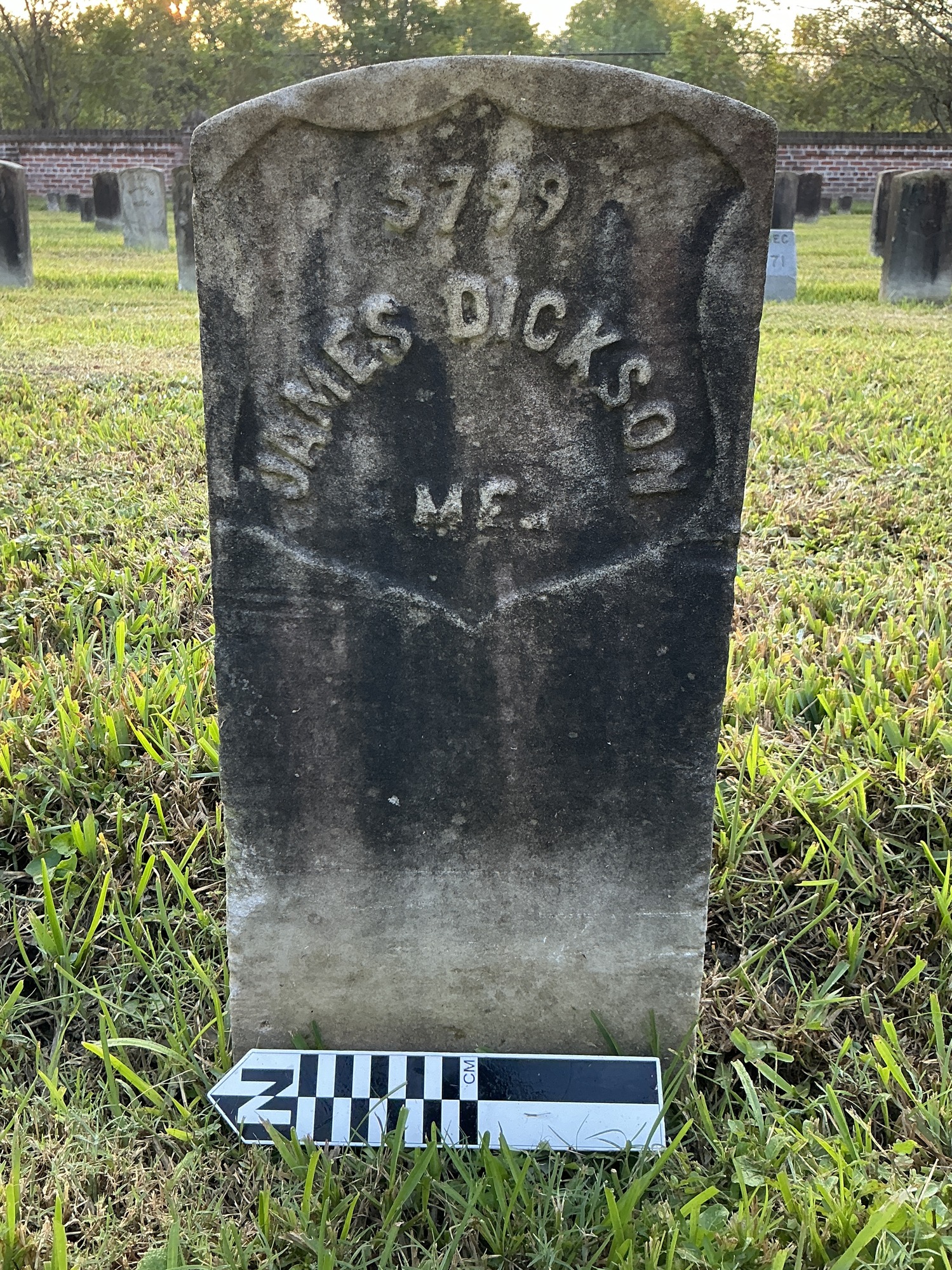 Extra image of historic upright marble headstone with recessed shield face.