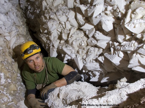 Caver squeezes through a narrow pinch point