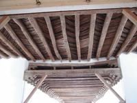 A wooden bridge with wooden beams.