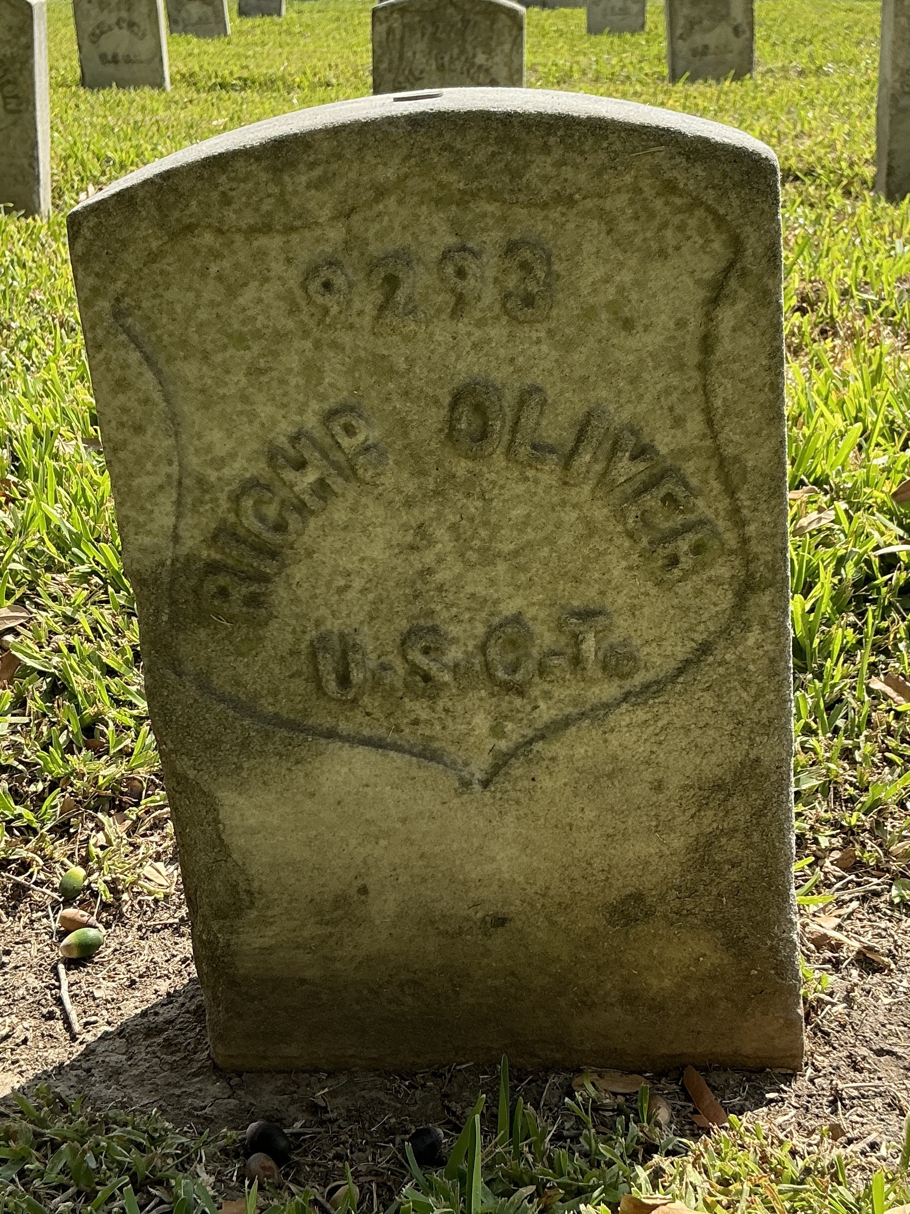 Front of historic upright marble headstone with recessed shield face.