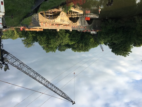 A crane over an arched bridge