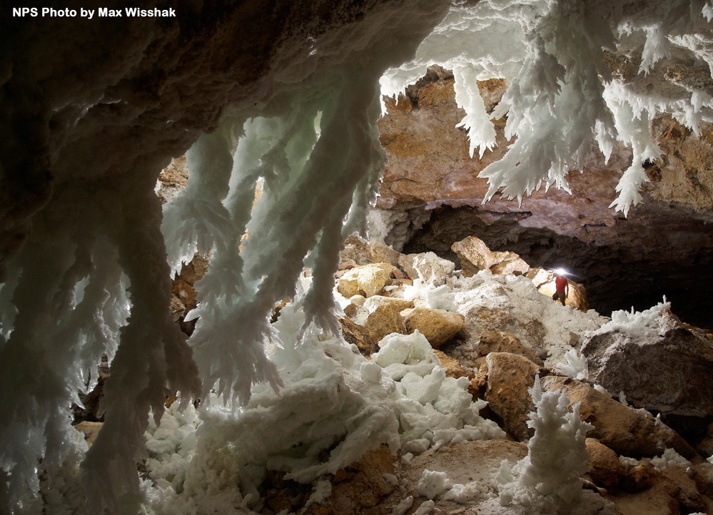 White gypsum chandeliers hang from the cave ceiling