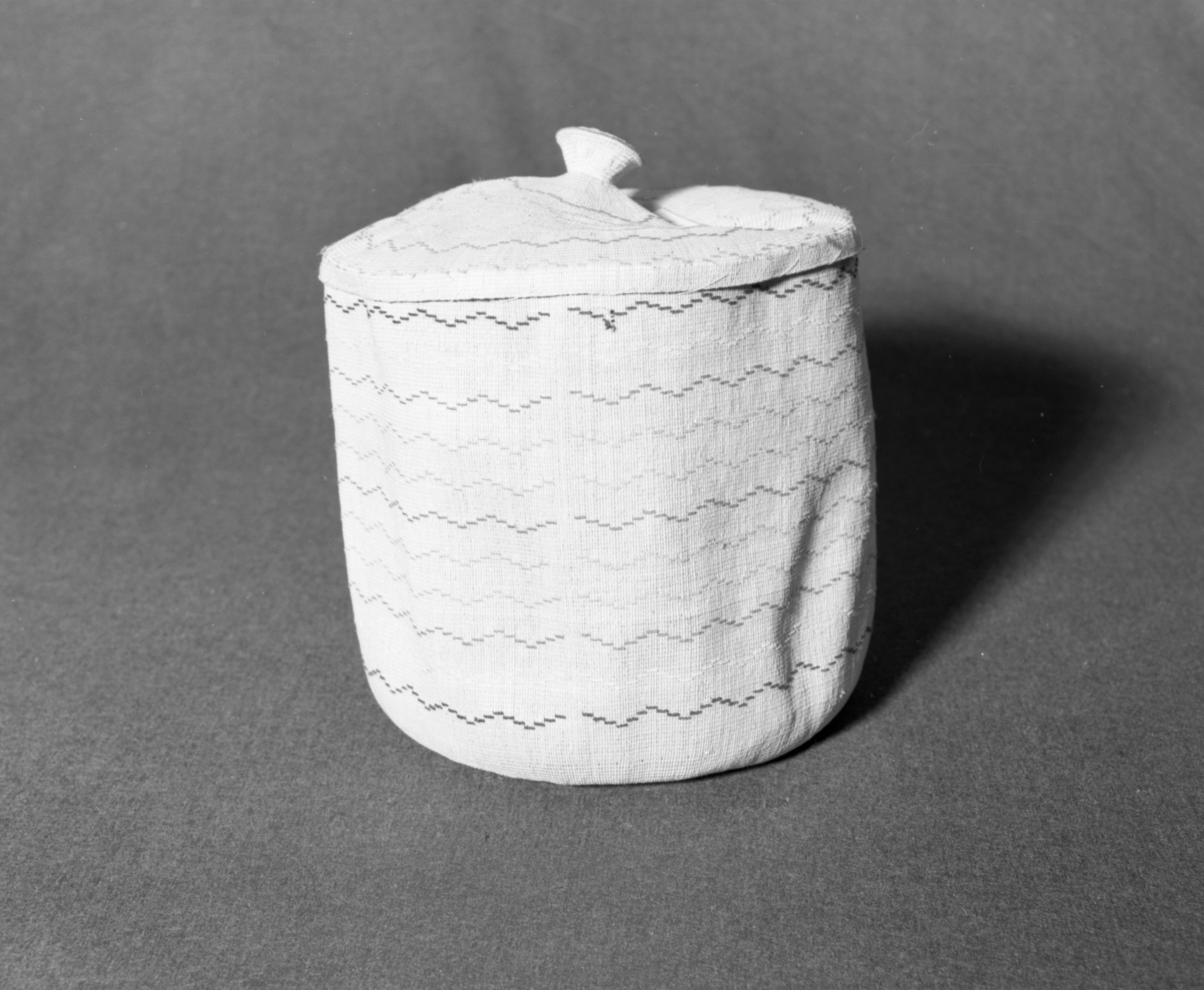 Marie Rozier Collection, Catalog No. 5-4. Object: Aleut basket. Dimensions: 10" x 9". Materials: grass, wool yarn. Technology: down to right slant of turns. Collection History: Gift of Flora Hill McCullough. Photographed by Michael Dixon, December 1982. Catalogued by Craig Bates and Barbara Beroza. Yosemite Collections, National Park Service.