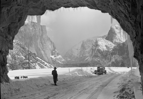 Dr. Huan-Kang Fu of the Chinese Ministry of Agriculture and Forestry at Wawona Tunnel. Dr. Fu enjoyed the view of Yosemite Valley on a typically stormy winter day. Here he is seen in the mouth og the Wawona Tunnel. Dr. Fu, a representative of the Chinese Govt., recently visited America leading a group of 200 Chinese technicians assigned to study various phases of agriculture, forestry and related sciences. He was especially interested in national parks here in connection with the possibility of establishing national parks in China for the preservation of natural features there.