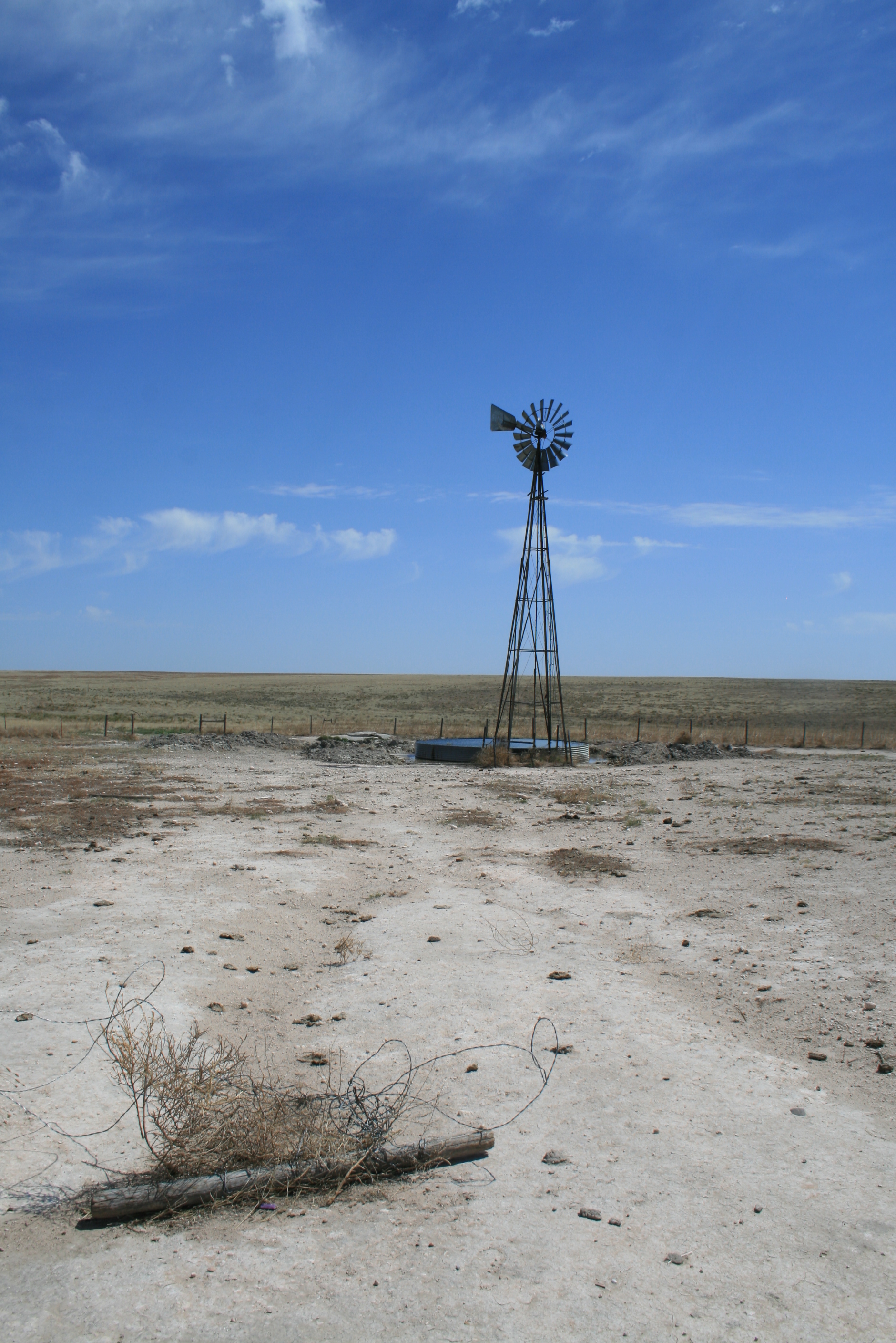 A windmill in the middle of a field.