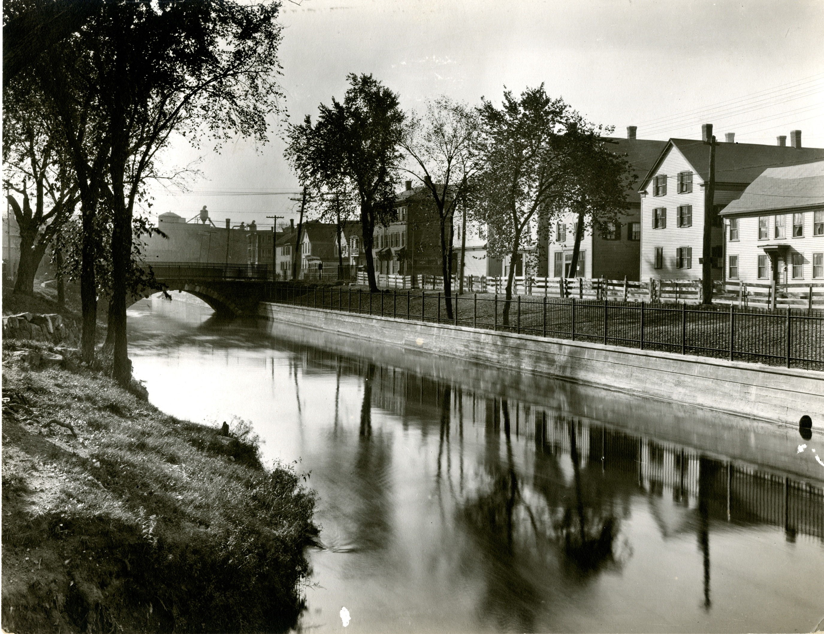 A photo showing a canal and homes.