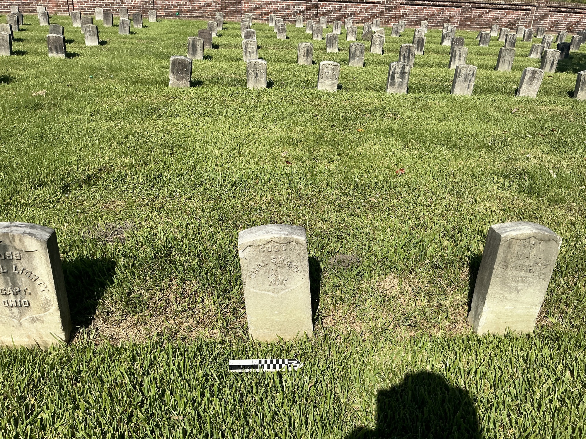 Extra image of historic upright marble headstone with recessed shield face.