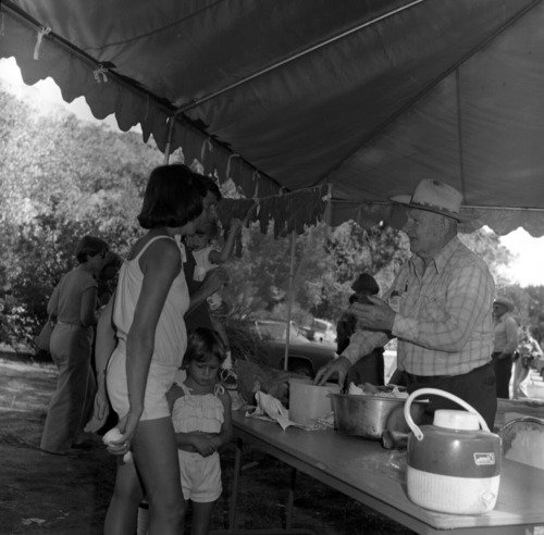 Dan Winder talks about making jerky with visitors and children. First annual Folklife Festival, Zion National Park Nature Center on September 1977.