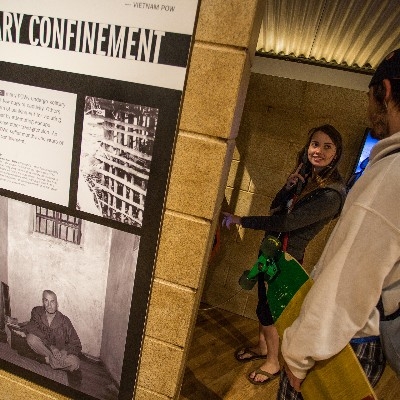Two young visitors use an interactive display