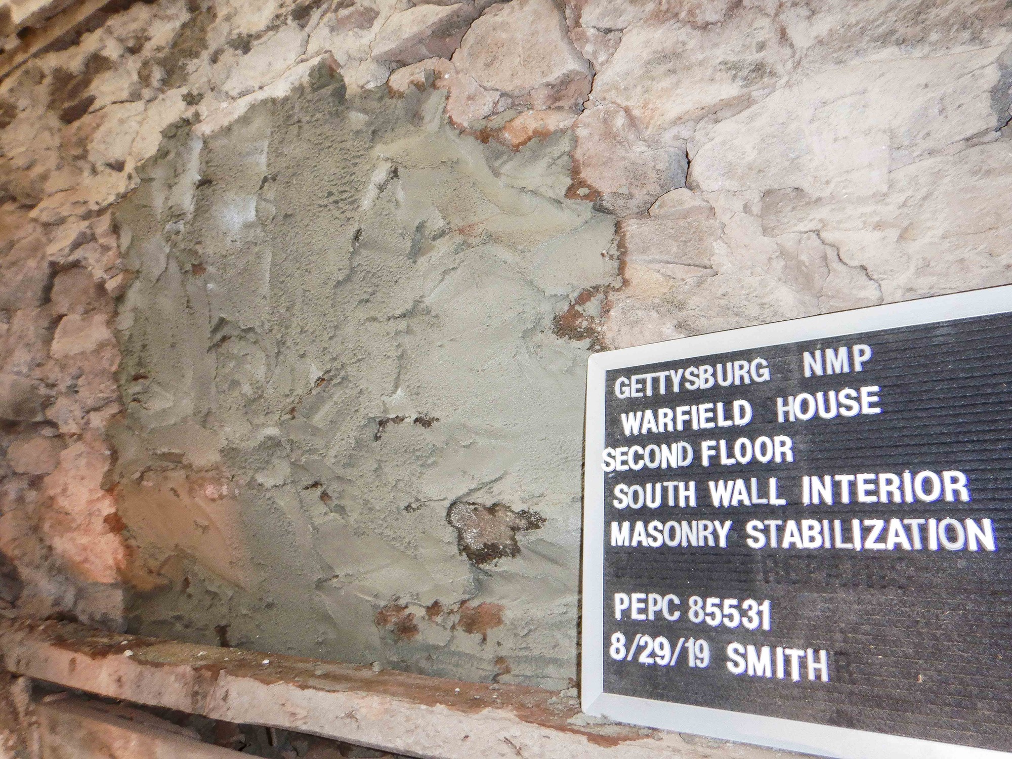 The masonry on the second floor, south wall interior after the stabilization process. The gap in the wall has been infilled with mortar. 