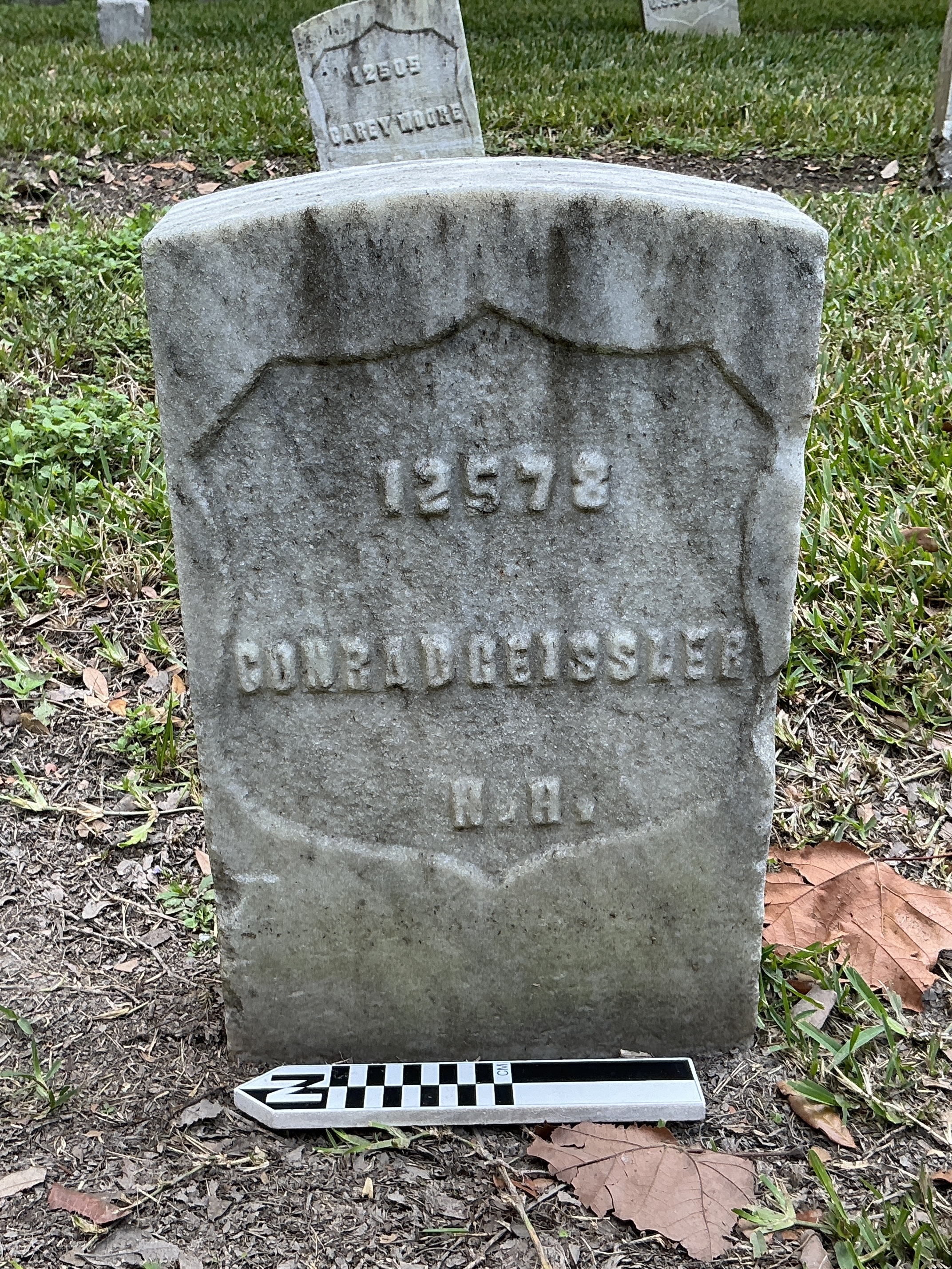 Extra image of historic upright marble headstone with recessed shield face.