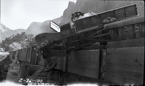 Vehicle accident on the Virgin River bridge of the Zion-Mt. Carmel Highway. View of a privately-owned truck turned on its side and resting on the bridge abutment.