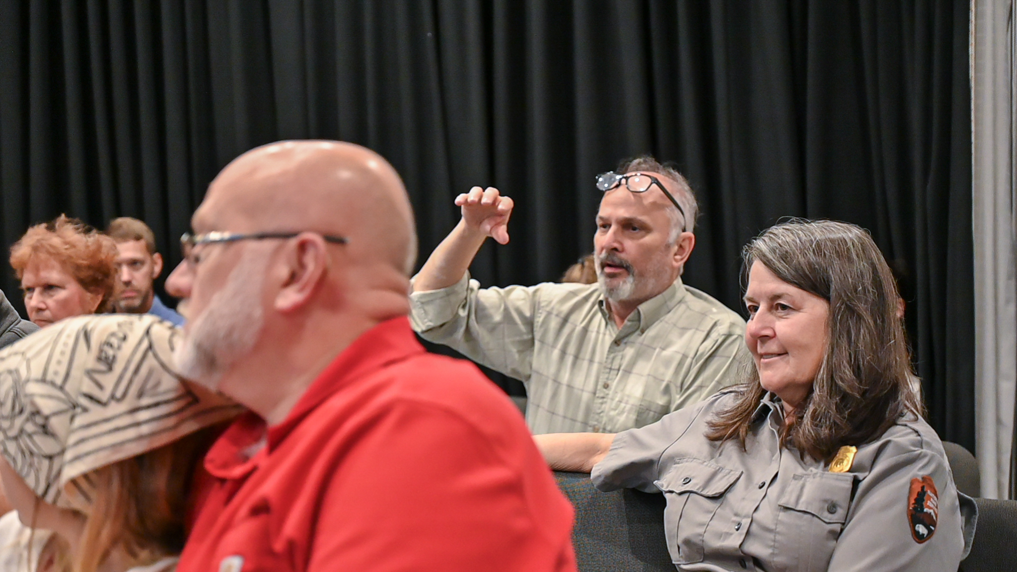 Visitors listening to the panel in the theater.