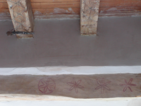A room with a wooden floor and a wooden ceiling.