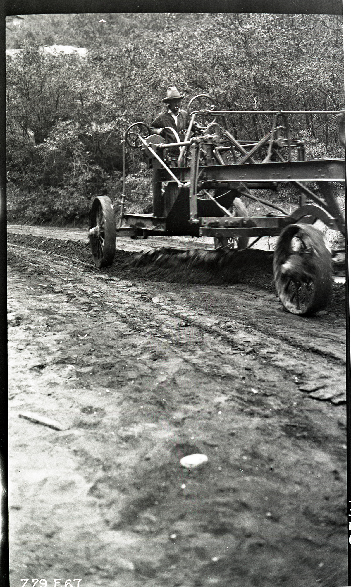 Worker driving a road grader in Zion Canyon.