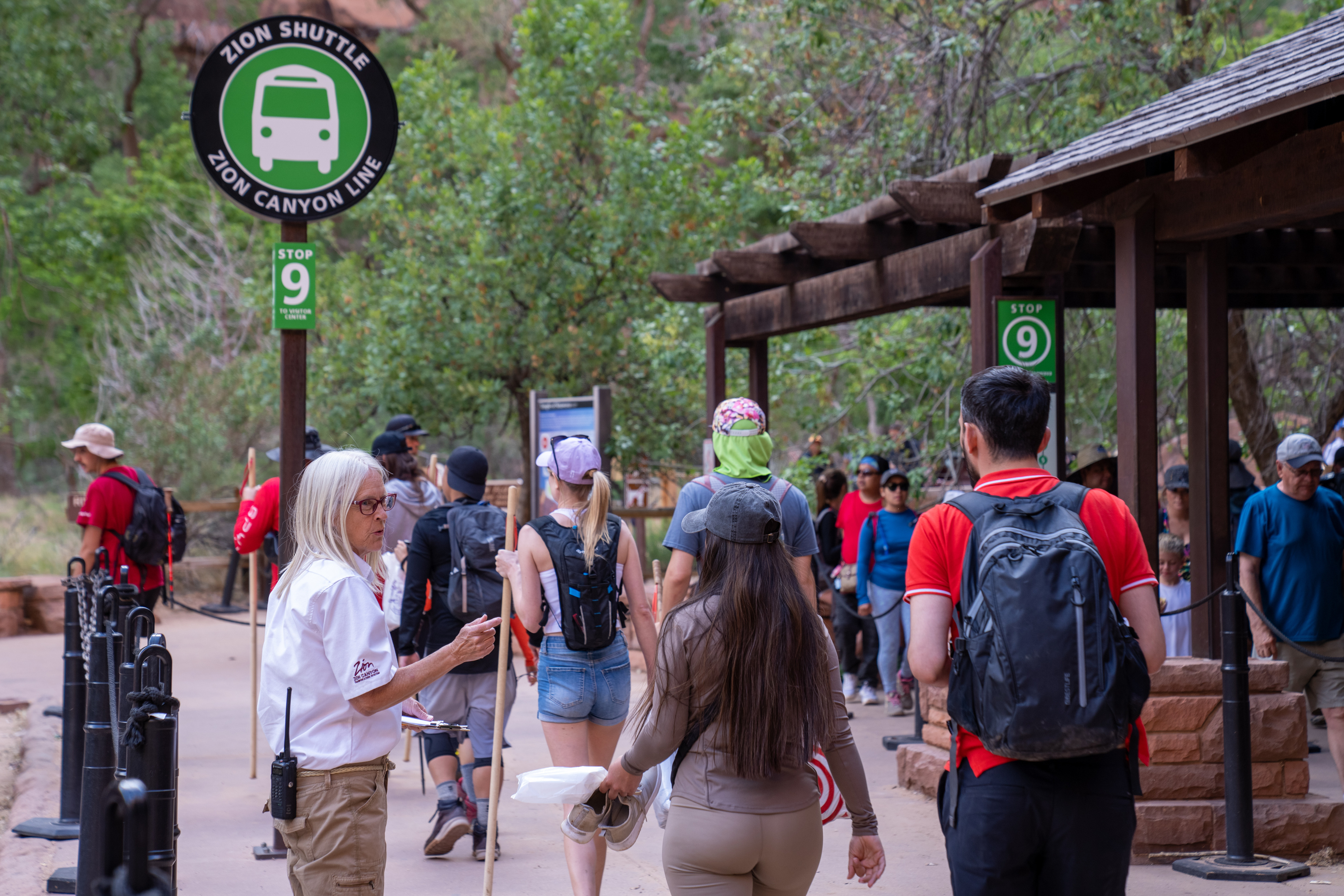 Visitors prepare to board shuttle at the Temple of Sinwava in Zion National Park.