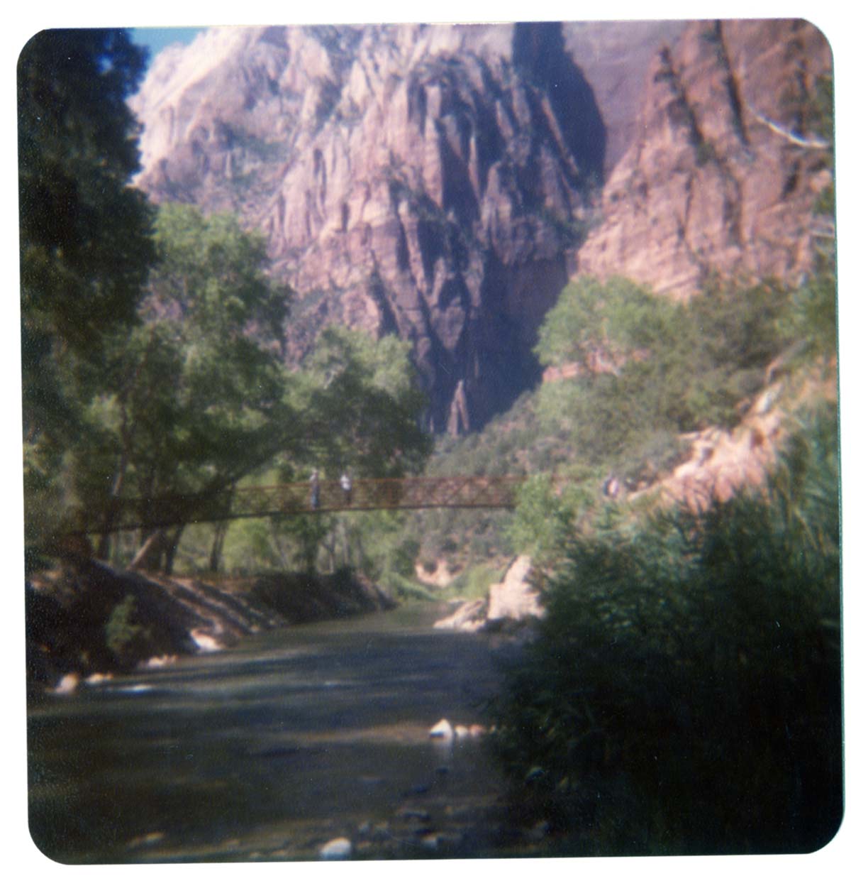 People standing on new Grotto footbridge over the Virgin River. Note riverbank revetments at left.