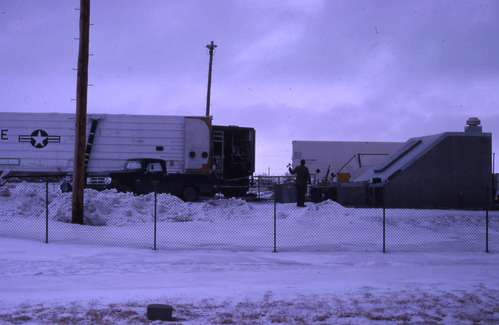 Vehicle and buildings in snowy landscape