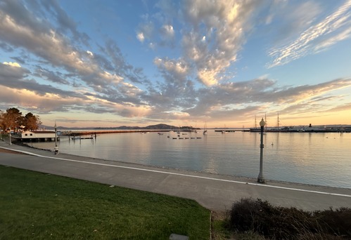 dramatic sunrise clouds reflect in the water of Aquatic Park Cove
