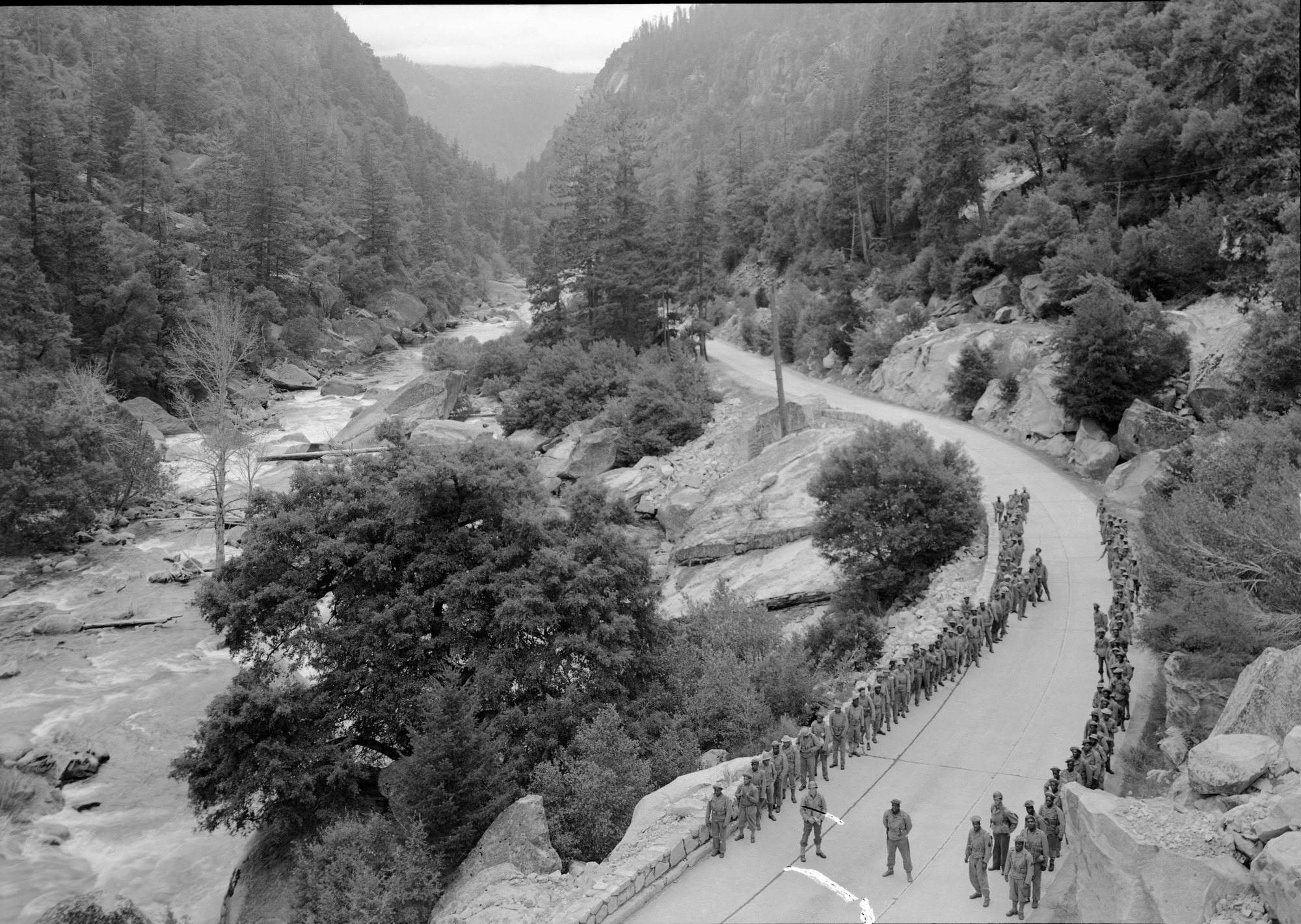 Hiking Soldiers of the 1914th Ordnance Co. on their conditioning march into Yosemite Valley. Merced R. Canyon in the distance.