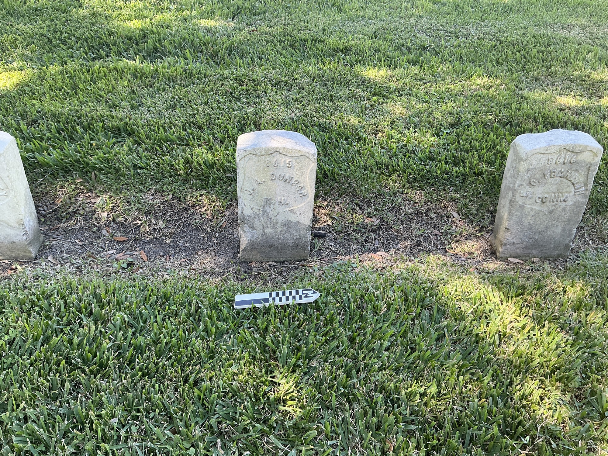 Extra image of historic upright marble headstone with recessed shield face.