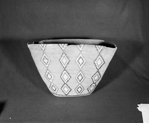 Marie Rozier Collection, Catalog No. 5-11-FM. Object: Salish storage basket. Dimensions: 15 x 25 x 16". Materials: Cedar root, cherry bark, beargrass. Technology: Rightward coil direction, split stitch, imbricated pattern. Collection History: From Flora Hill McCullough Collection. Photographed by Michael Dixon, December 1982. Catalogued by Craig Bates and Barbara Beroza. Yosemite Collections, National Park Service.