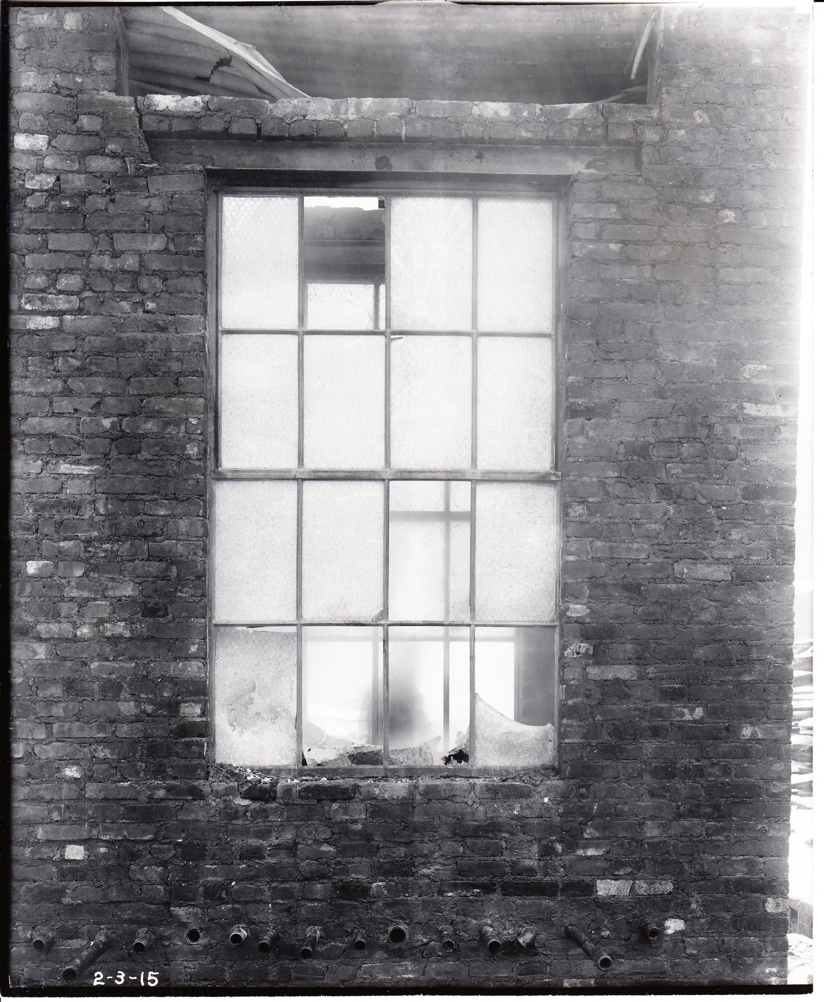 Specially constructed chimney for testing two kinds of wire- glass windows with steel frames and sash, lupton, one hour after test.
