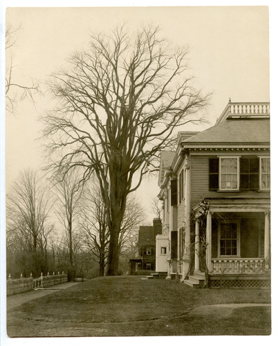 Black and white photograph of front corner of Georgian mansion.