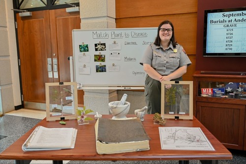 Staff member at the Healing and Hardship table