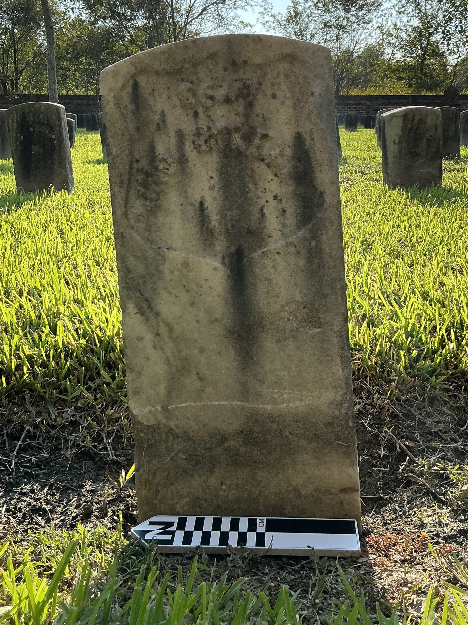 Extra image of historic upright marble headstone with recessed shield face.