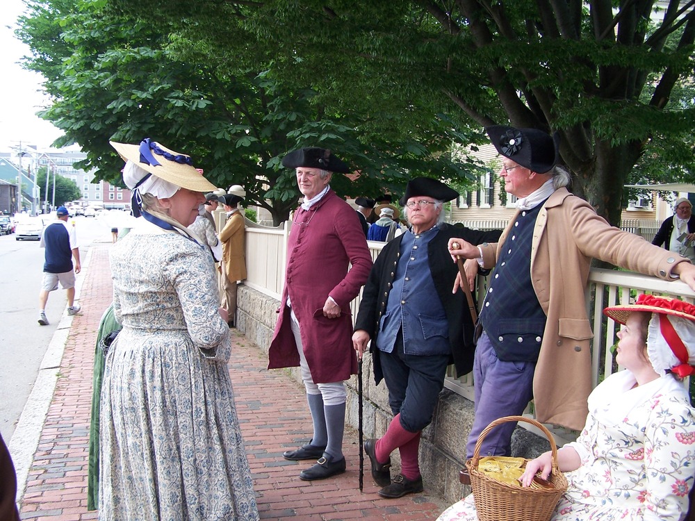 men and women dressed in colonial clothing