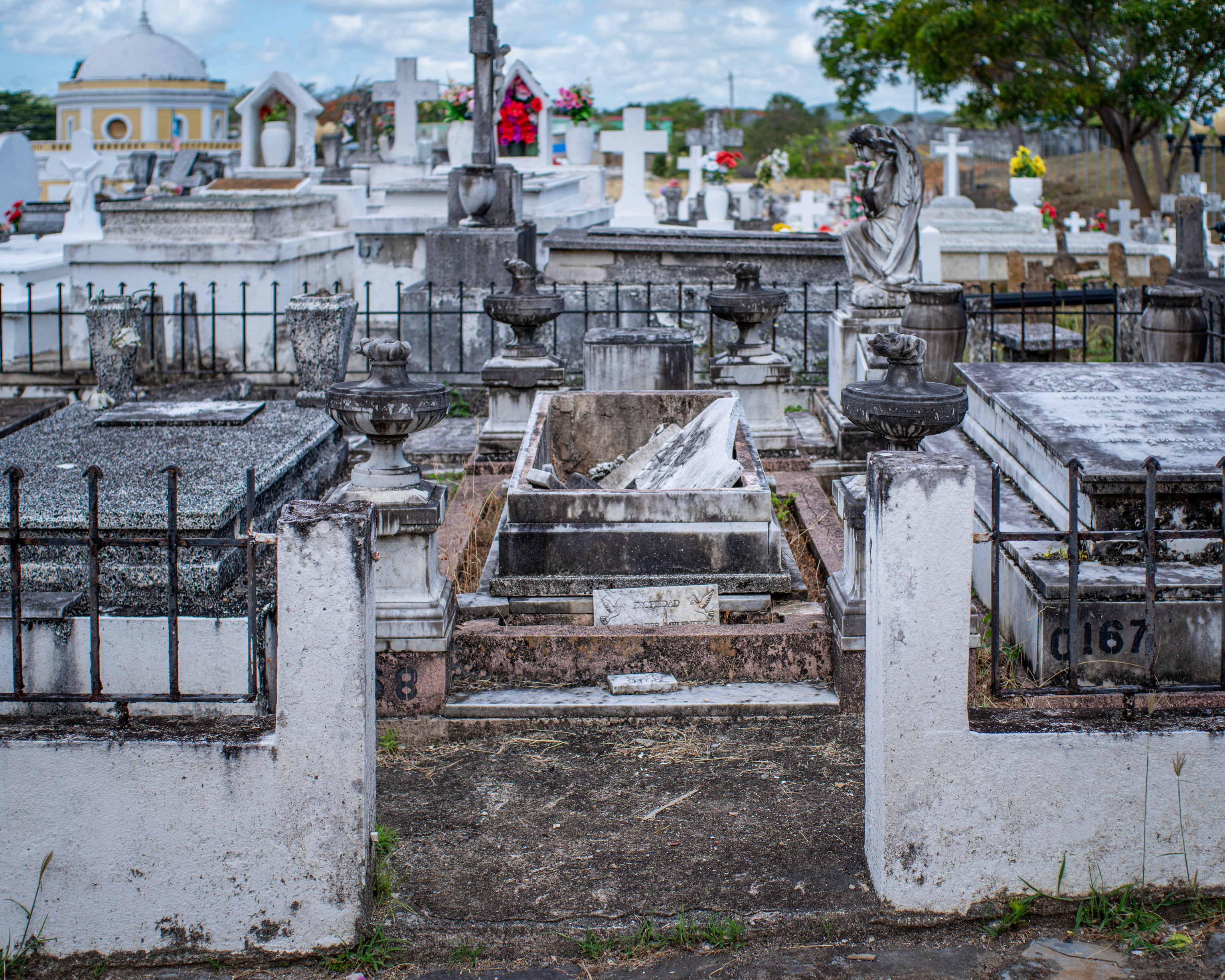Family plot of four (shown) tombs.  Center tomb has a broken marble slab top.