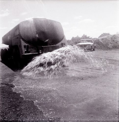 Construction vehicle spraying chipsealing of Kolob Canyon Road.