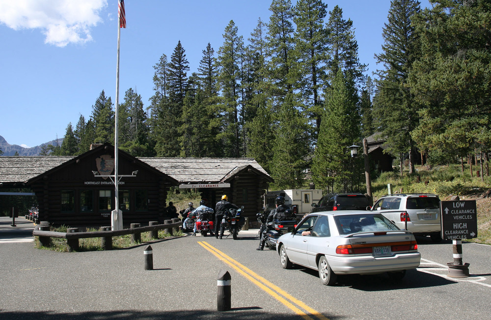 Log building with cars lined up by it awaiting entrance