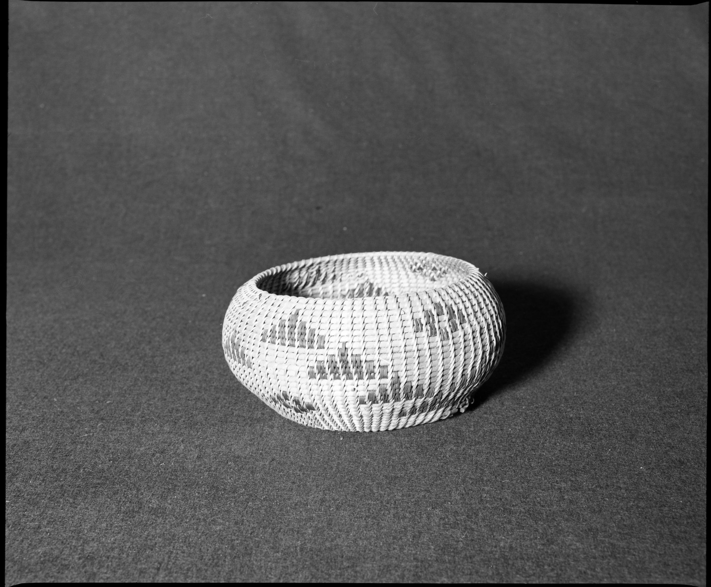 Marie Rozier Collection, Catalog No. 118. Object: Washoe basket. Dimensions: 7 x 3 1/2". Materials: Willow, fern, redbud. Technology: Non-interlocking stitching, design filled in between rows of stitching, type made for sale. Collection History: Acquired from Mrs. DuGay. Photographed by Michael Dixon, December 1982. Catalogued by Craig Bates and Barbara Beroza. Yosemite Collections, National Park Service.