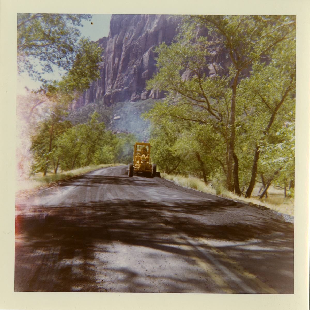 Tractor performing shoulder work along route 2 parking areas.