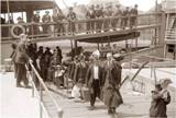 Immigrants getting off the ferry at Ellis Island