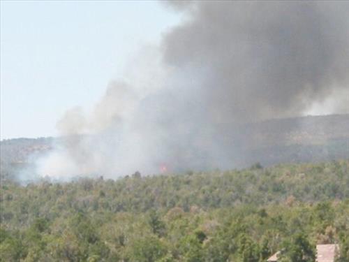 Full fire with black smoke advancing on buildings on the first day of Long Mesa Fire, Mesa Verde National Park, July 29, 2002