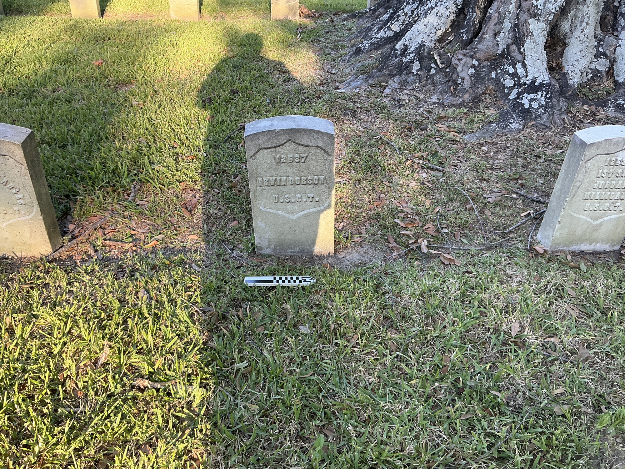 Extra image of historic upright marble headstone with recessed shield face.