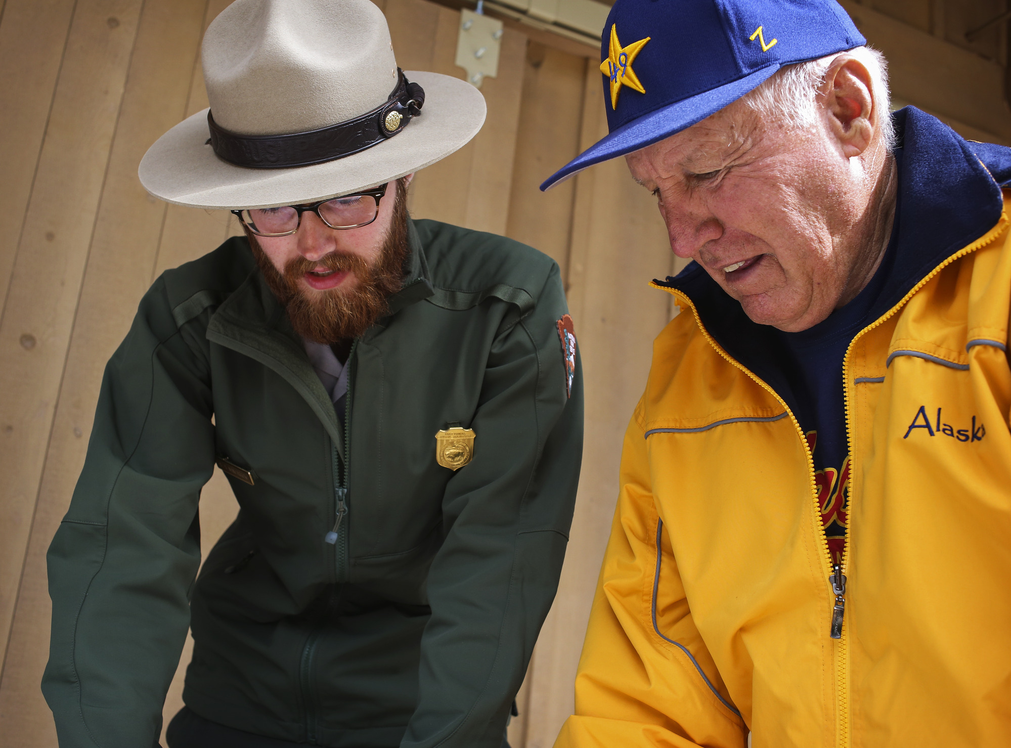 a park ranger speaking to a man