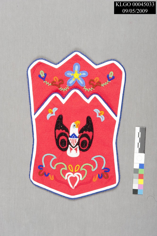 color photo of red beaded pouch, pouch has an eagle design and is crown shaped with an inverted w shaped edge to pocket